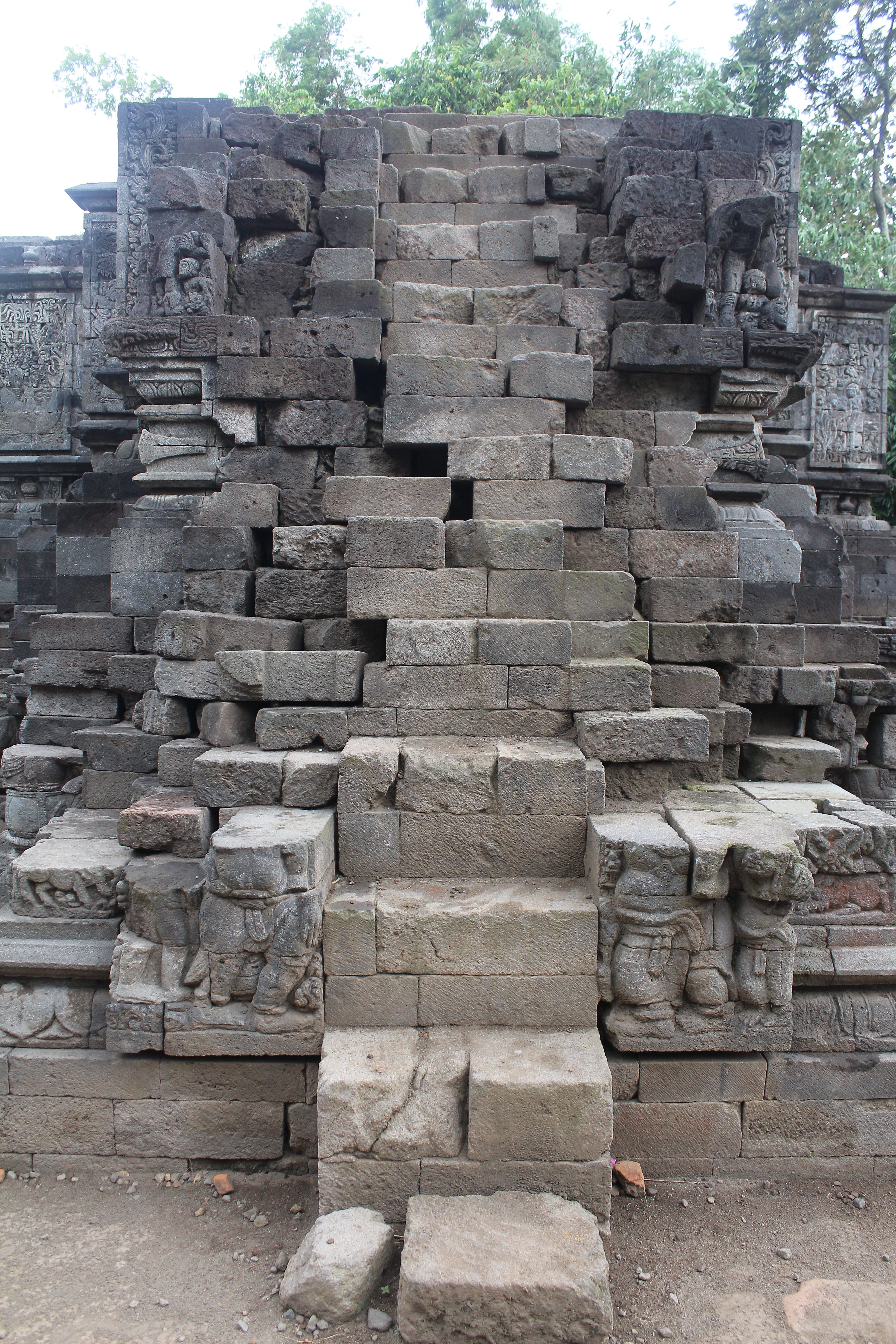 Platform-style temple with relief carvings on all sides