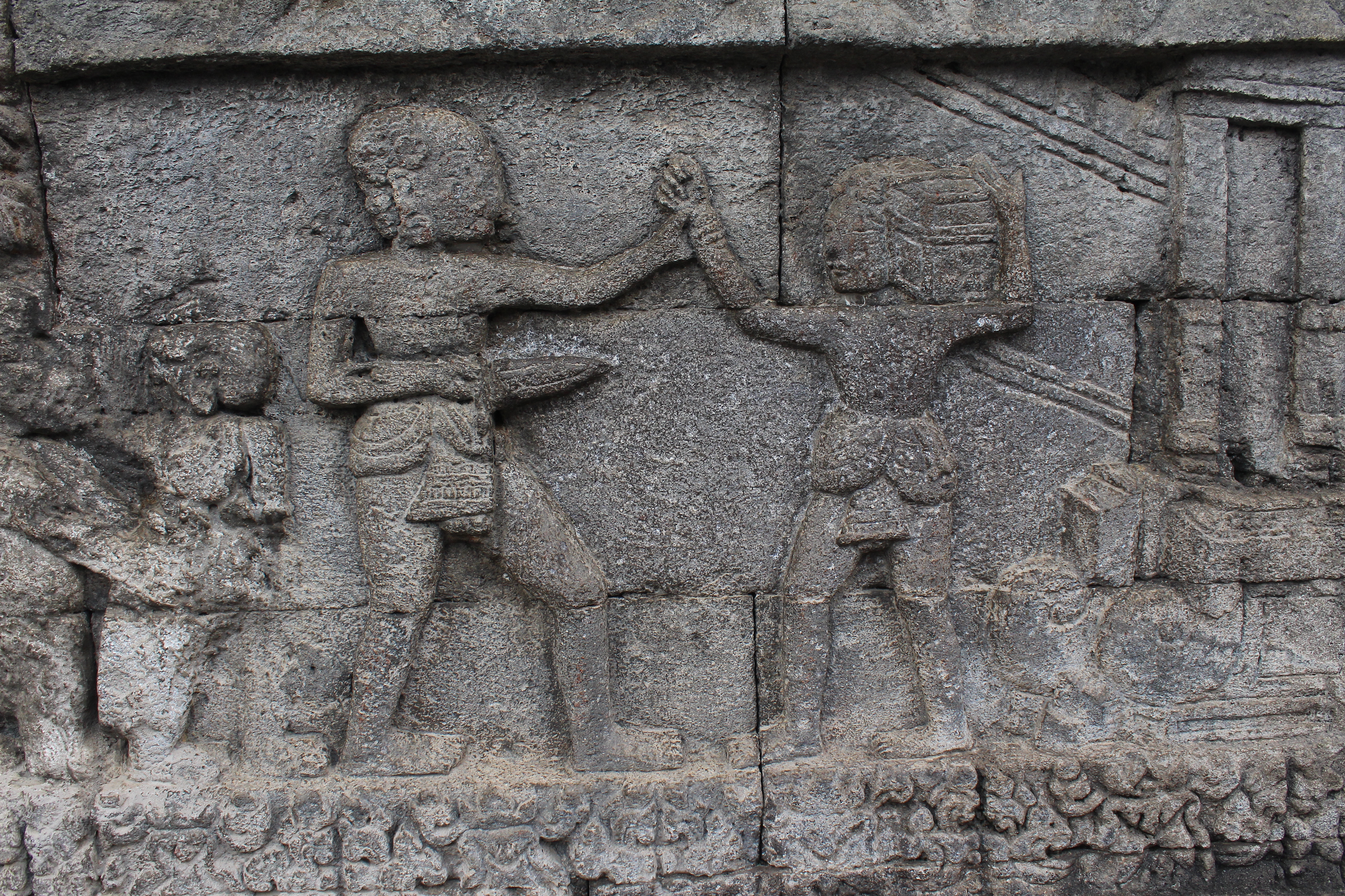 Relief showing two people fighting