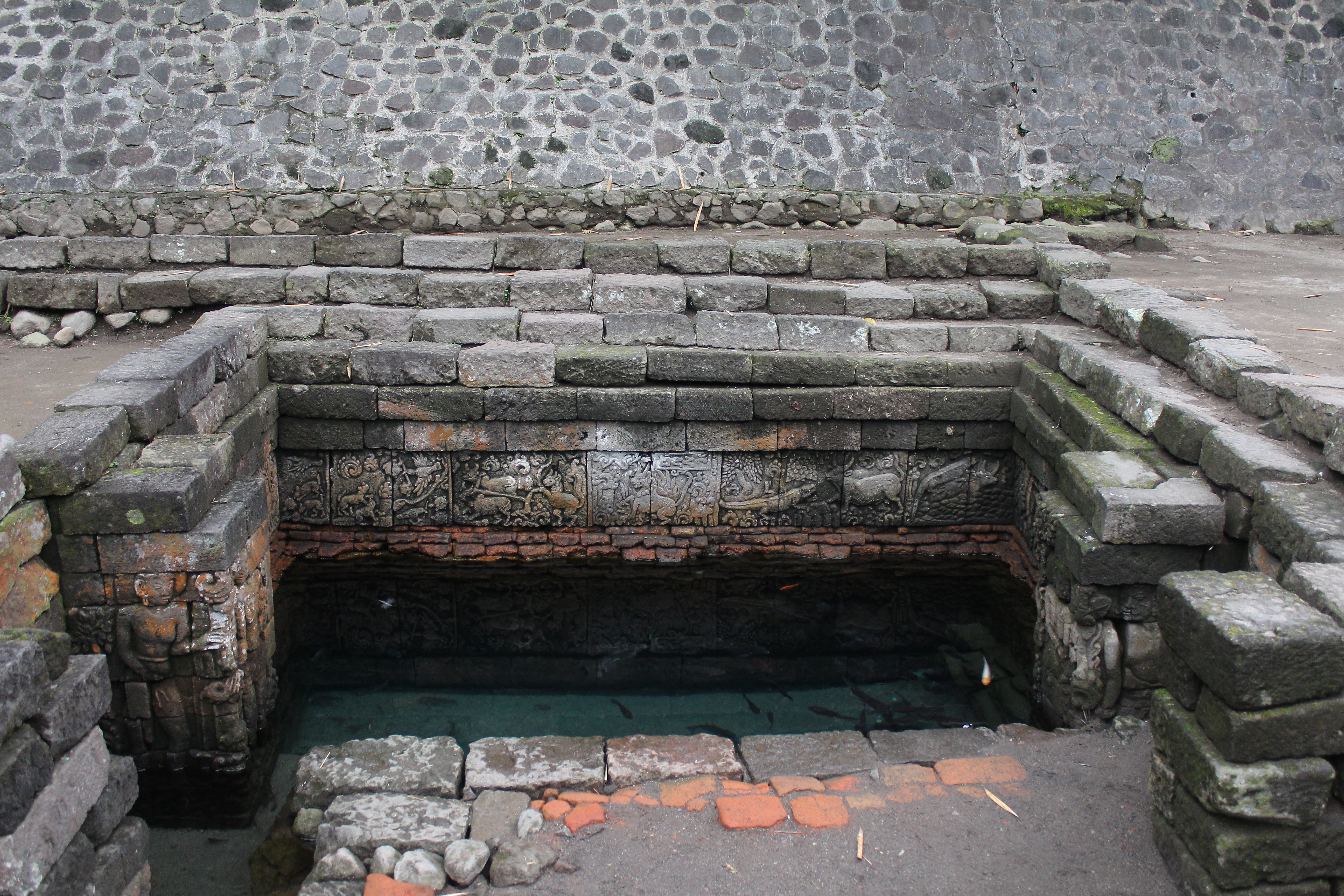 Small pool with relief carvings around edges