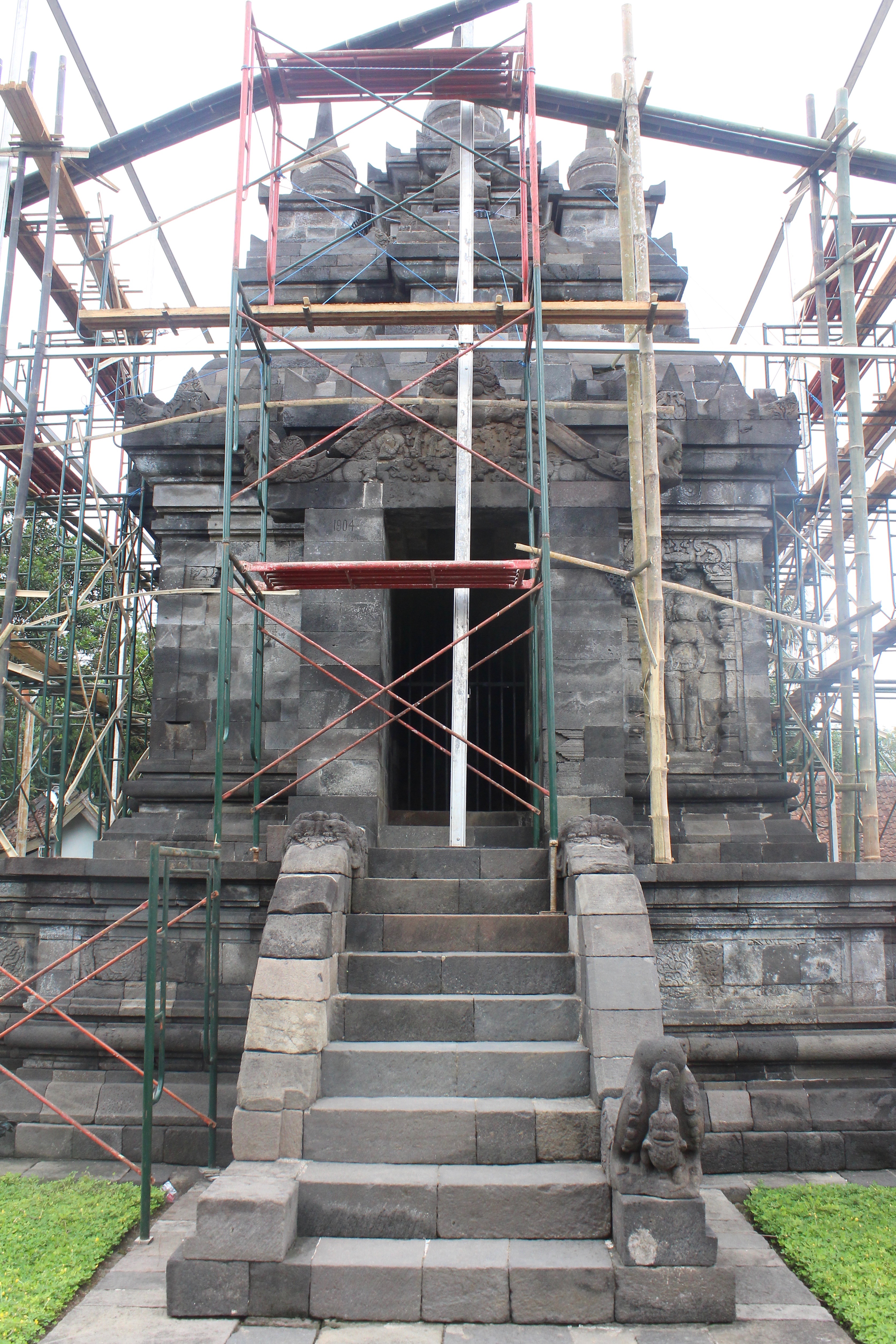 Stone temple covered by wood scaffolding