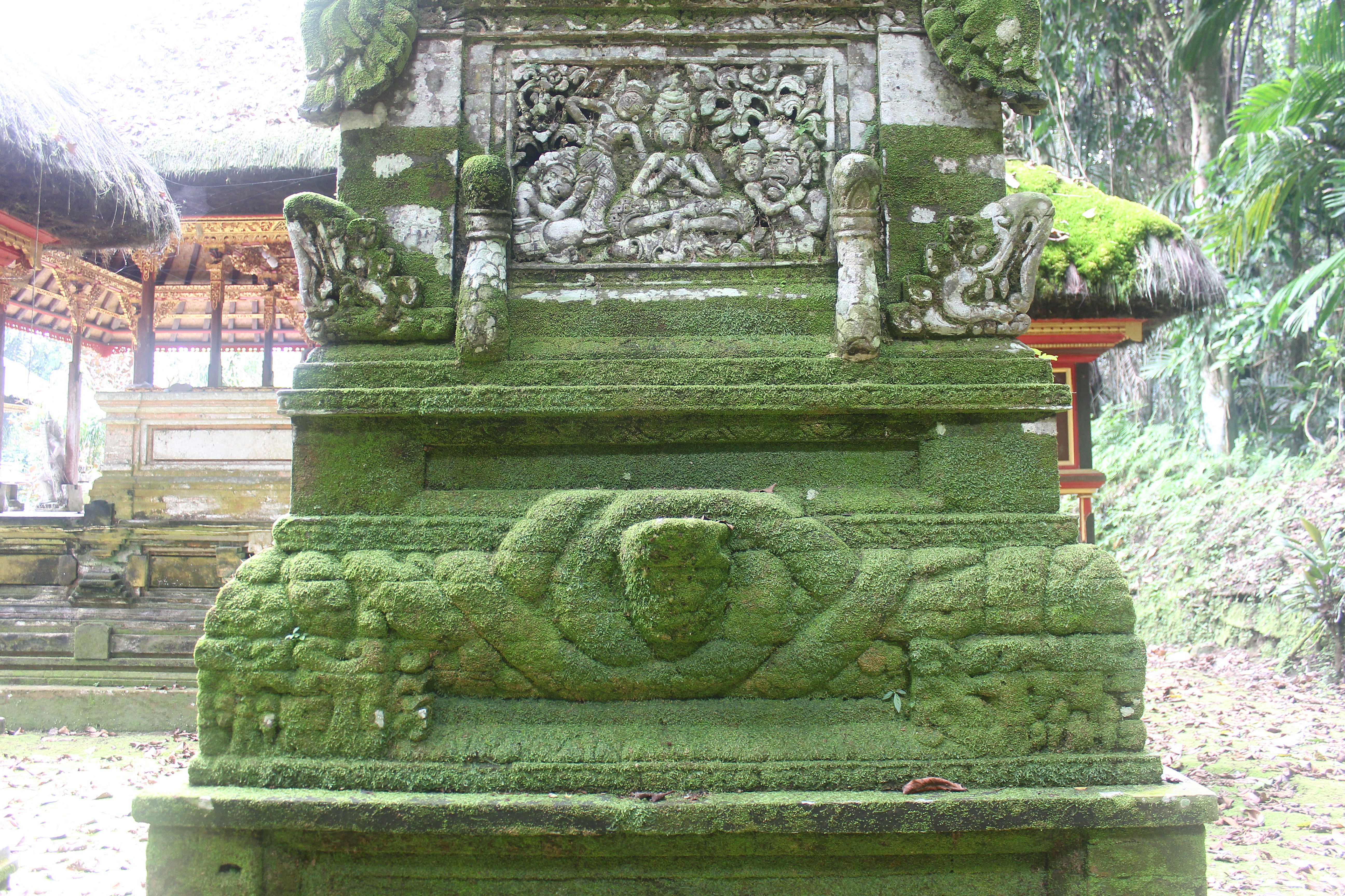 Overgrown shrine with serpent carvings