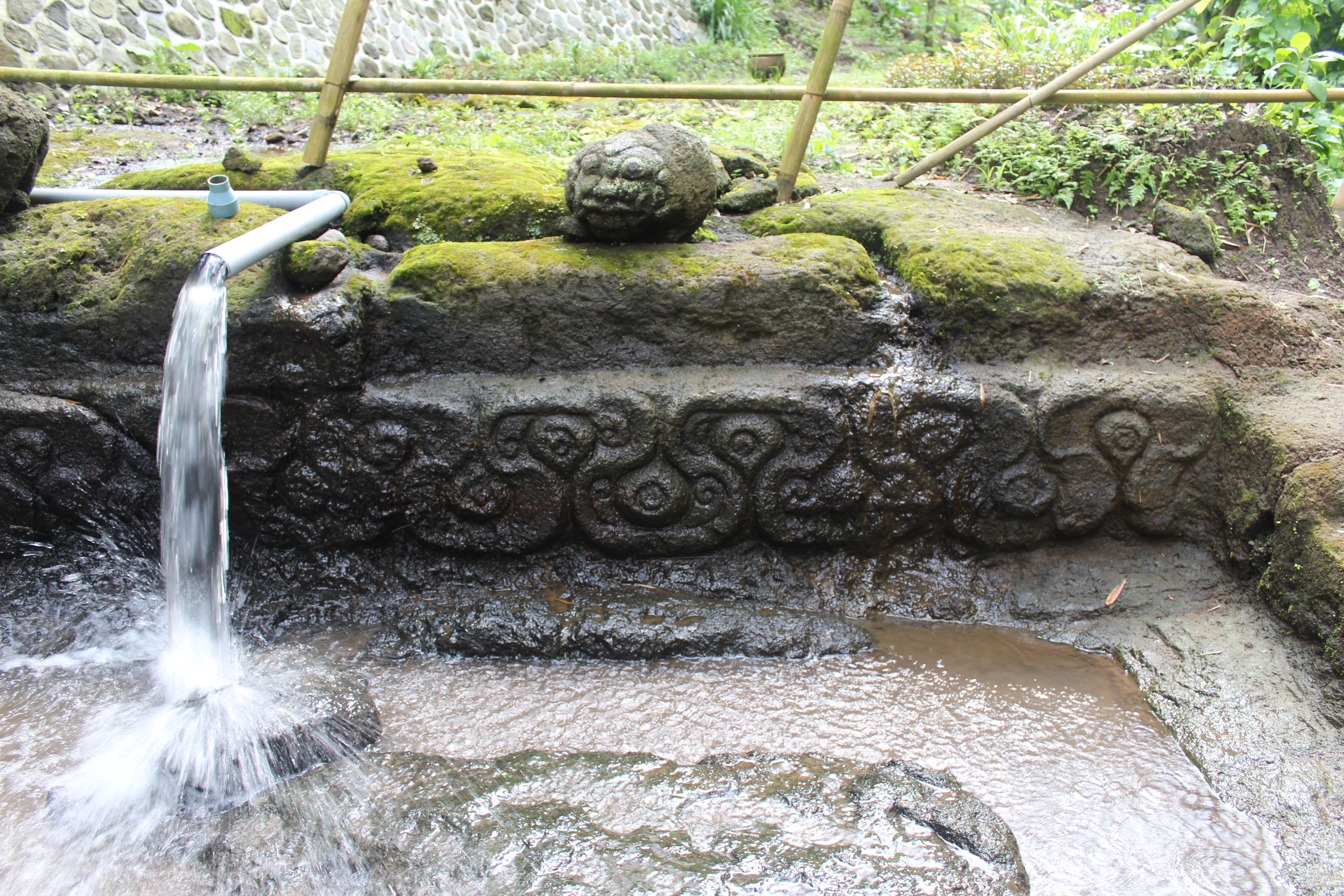 Water pouring into bathing pool, with rakshasa head and carved ornament